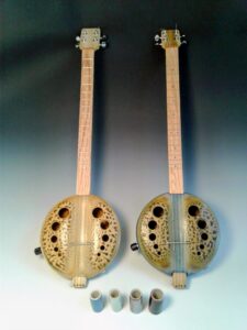 Two string instruments. The body is made out of ceramics.